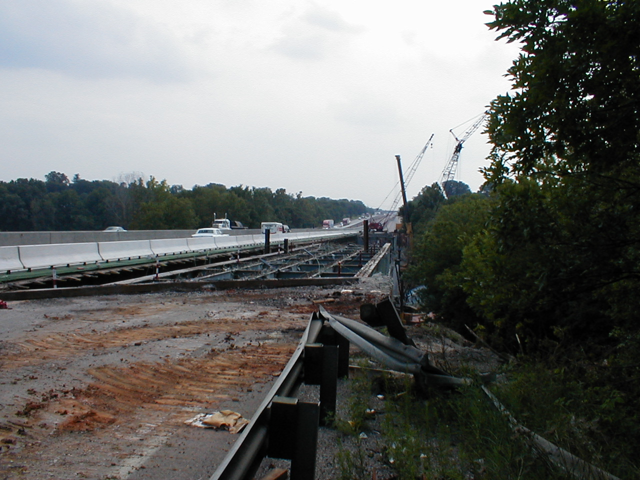 This shows the south bound bridge being dismantled. Traffic traveling in the temporary south bound lanes and old north bound lanes is visible.