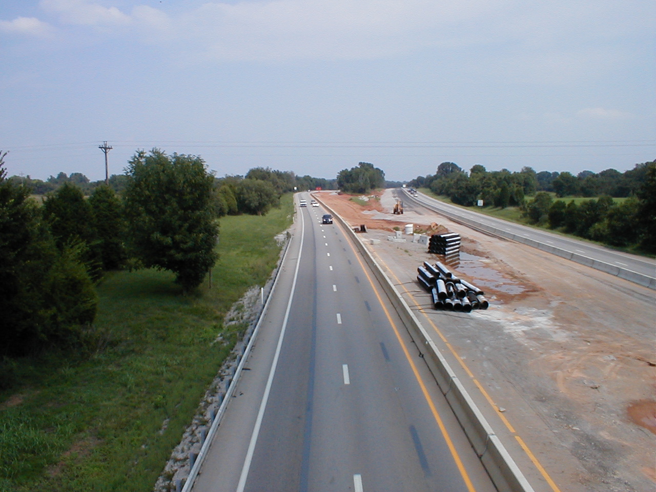 A traffic island on I-65. New lanes being added to both the north and south bound lanes are visible.