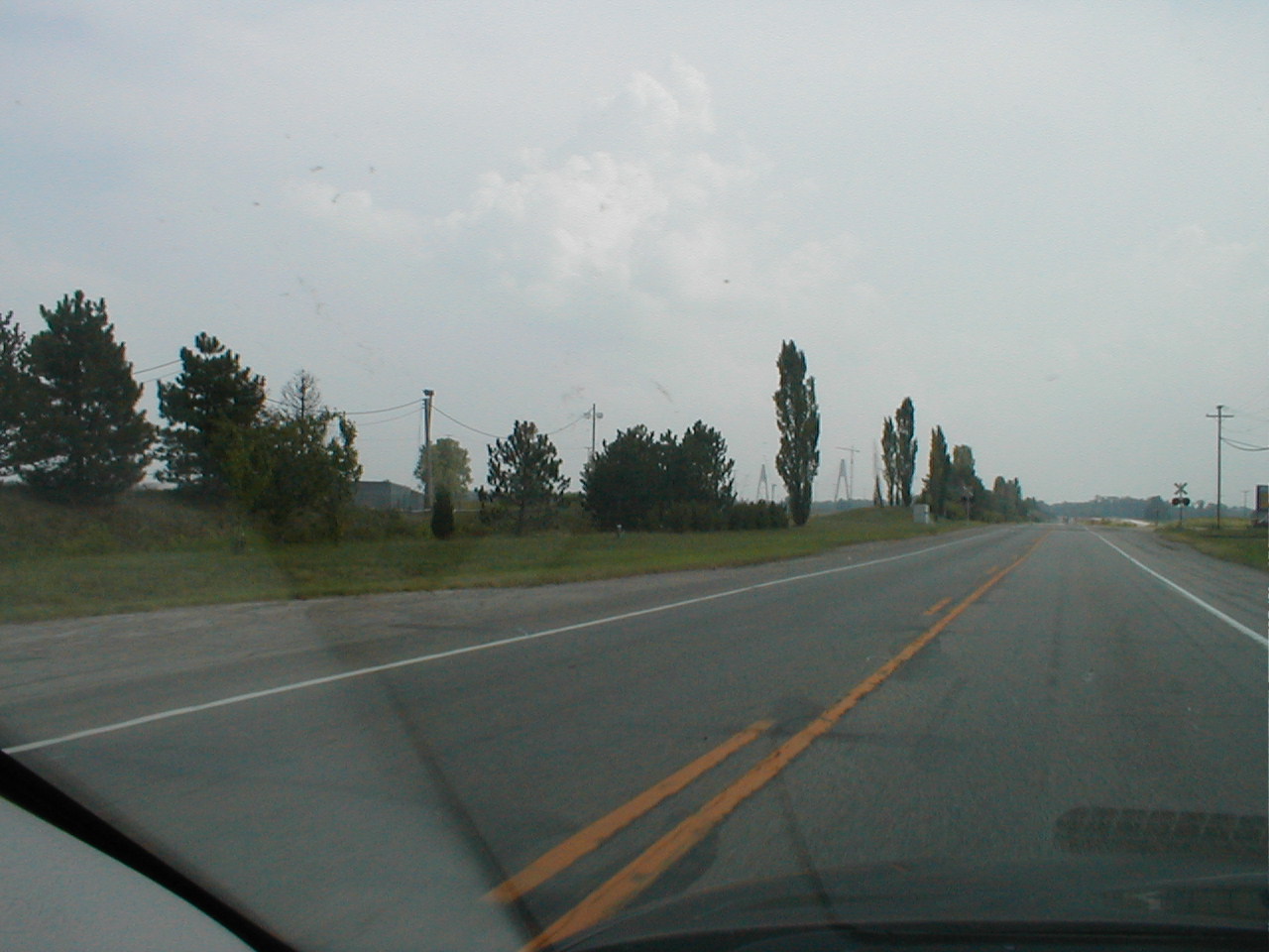 Facing south on US 231 towards the bridge. The bridge towers are visible between the trees.