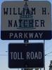A sign for the William H. Natcher Parkway. Also includes a "Toll Road" banner.